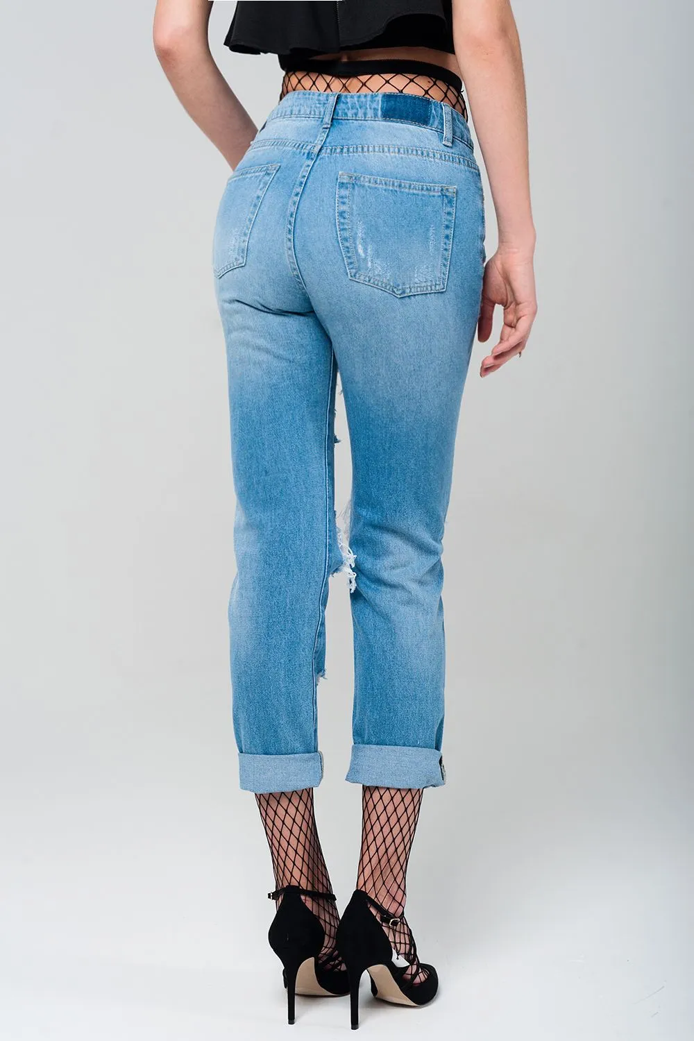 Ripped mom jeans with fishnet tights